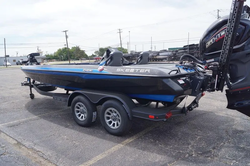 Slide: The Image of 2026 Skeeter ZXE21 boat on trailer in parking lot, side view. - 14