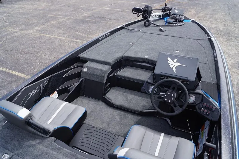 Slide: The Image of 2026 Skeeter ZXE21 boat interior with steering wheel and seating, showcasing modern design. - 15