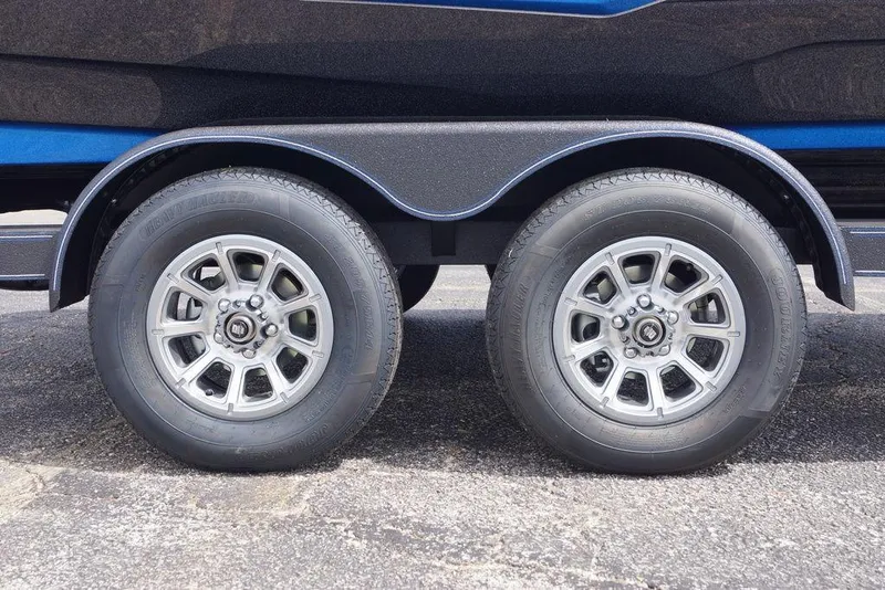 Slide: The Image of 2026 Skeeter ZXE21 trailer wheels on asphalt, showcasing dual tire design. - 2
