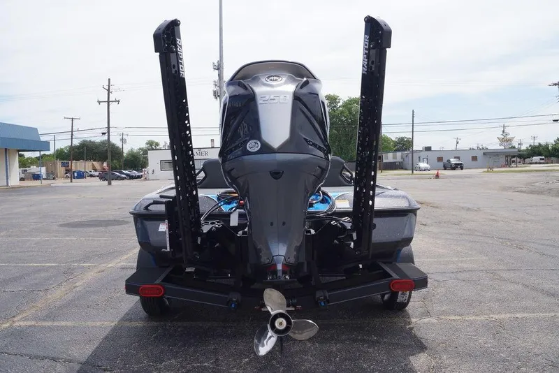 Slide: The Image of 2026 Skeeter ZXE21 boat with powerful outboard motor in a parking lot. - 8