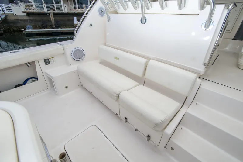Slide: The Image of 2002 Tiara Yachts 4100 Open interior with white seating and rod holders. - 16