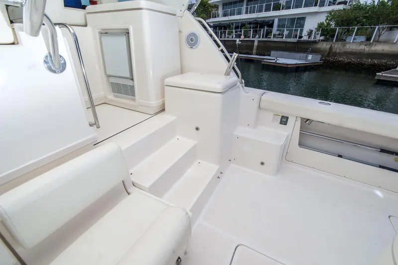 Slide: The Image of 2002 Tiara Yachts 4100 Open boat interior with seating and steps by the water. - 17