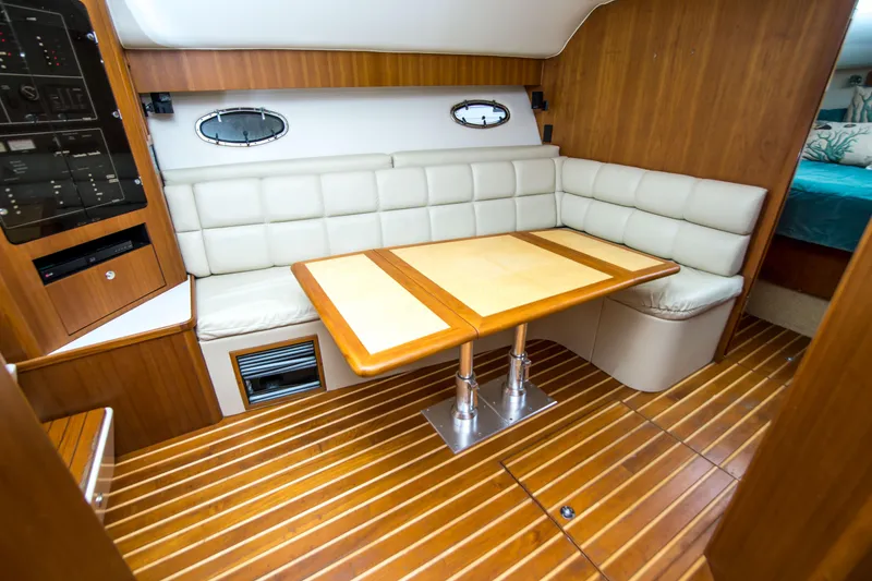 Slide: The Image of Luxurious interior of 2002 Tiara Yachts 4100 Open with wood flooring and plush seating. - 23