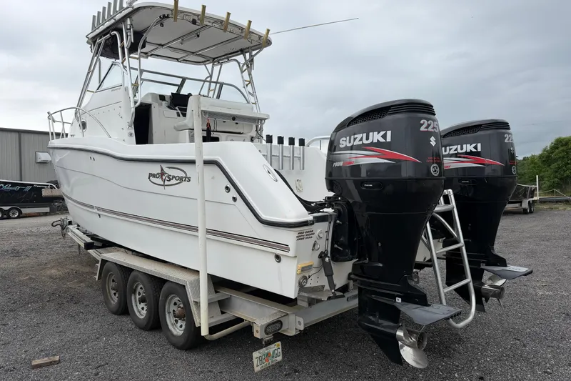 Slide: The Image of 2004 Pro Sports 2660 WA ProKat boat with dual Suzuki 225 engines on trailer. - 1