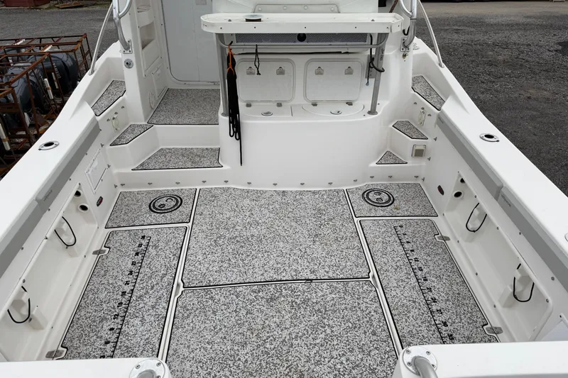 Slide: The Image of 2004 Pro Sports 2660 WA ProKat boat deck with non-slip flooring and storage compartments. - 11