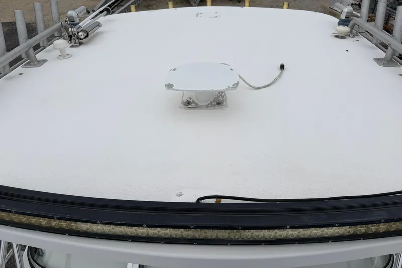 Slide: The Image of 2004 Pro Sports 2660 WA ProKat boat deck with mounted equipment and railing. - 15