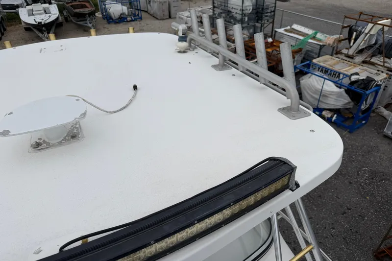 Slide: The Image of 2004 Pro Sports 2660 WA ProKat boat roof with rod holders and light bar. - 16