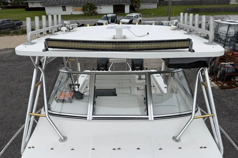 Slide: The Image of 2004 Pro Sports 2660 WA ProKat boat with T-top and rod holders. - 18
