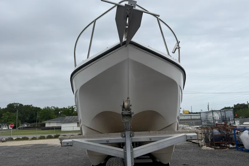 Slide: The Image of 2004 Pro Sports 2660 WA ProKat boat on trailer, front view, overcast sky. - 19