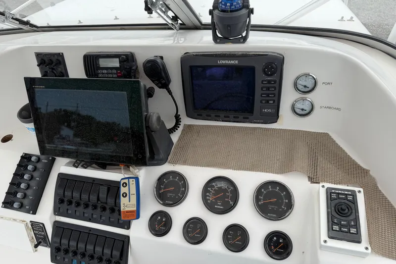 Slide: The Image of Control panel of 2004 Pro Sports 2660 WA ProKat boat with navigation instruments. - 2