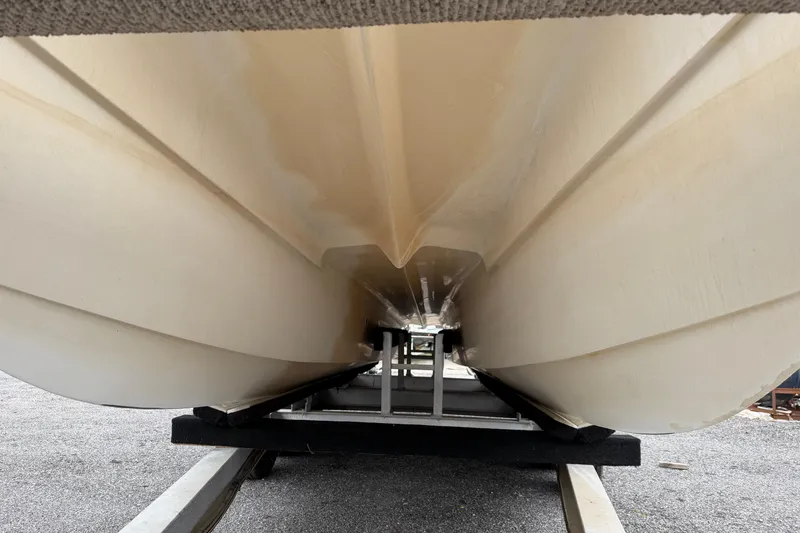 Slide: The Image of 2004 Pro Sports 2660 WA ProKat boat hull on trailer, showcasing underside design. - 20
