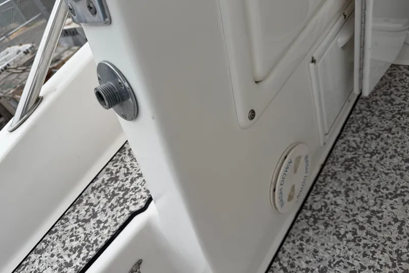 Slide: The Image of 2004 Pro Sports 2660 WA ProKat boat interior detail with textured flooring and storage compartments. - 26