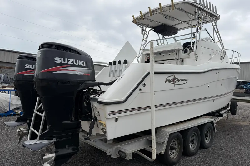 Slide: The Image of 2004 Pro Sports 2660 WA ProKat boat with dual Suzuki outboard motors on trailer. - 3