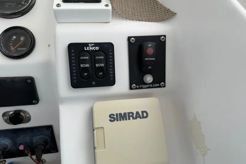 Slide: The Image of Control panel of a 2004 Pro Sports 2660 WA ProKat boat with Lenco and Simrad systems. - 30