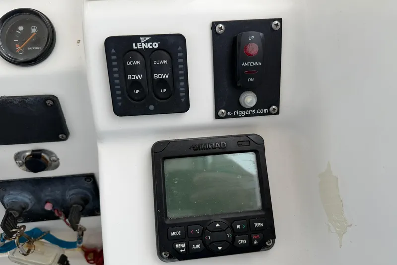 Slide: The Image of 2004 Pro Sports 2660 WA ProKat boat controls with Lenco trim tabs and Simrad display. - 31