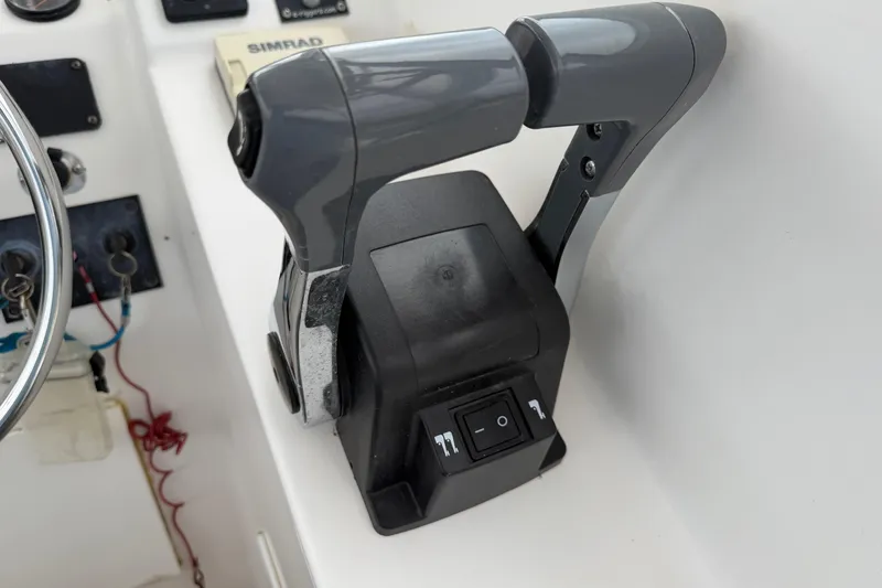 Slide: The Image of Throttle controls on a 2004 Pro Sports 2660 WA ProKat boat dashboard. - 32