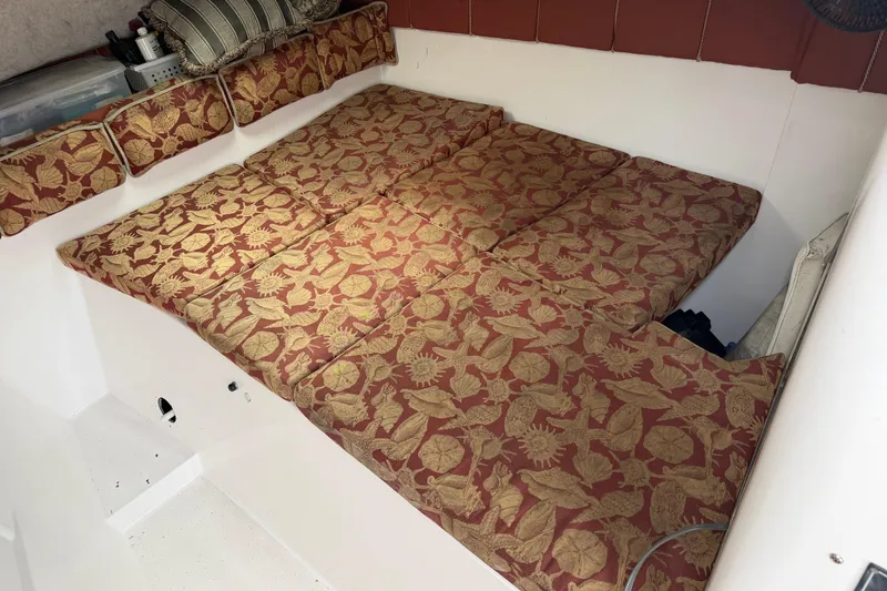 Slide: The Image of 2004 Pro Sports 2660 WA ProKat cabin with patterned cushions and storage. - 33