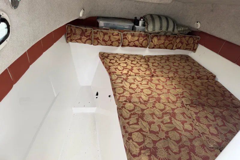 Slide: The Image of 2004 Pro Sports 2660 WA ProKat cabin interior with patterned cushions and storage. - 34