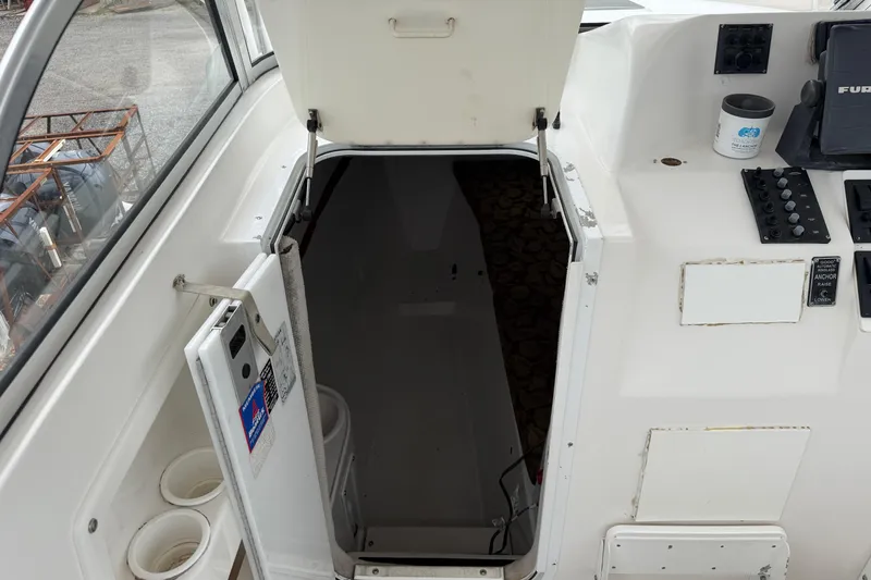 Slide: The Image of 2004 Pro Sports 2660 WA ProKat boat cabin entrance with control panel and cup holders. - 35