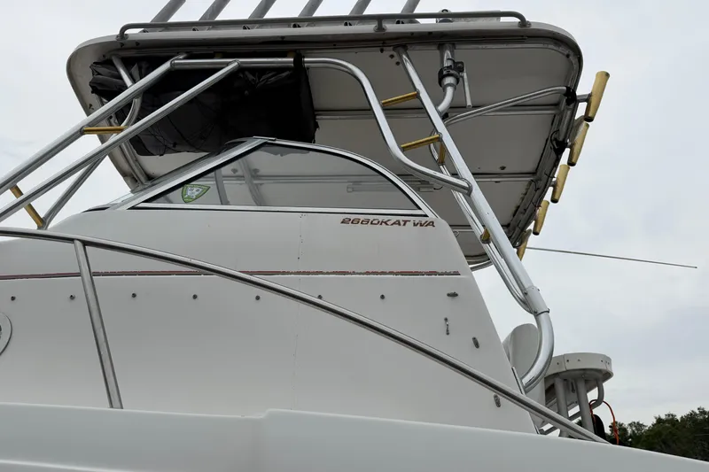 Slide: The Image of 2004 Pro Sports 2660 WA ProKat boat with metal framework and canopy. - 7