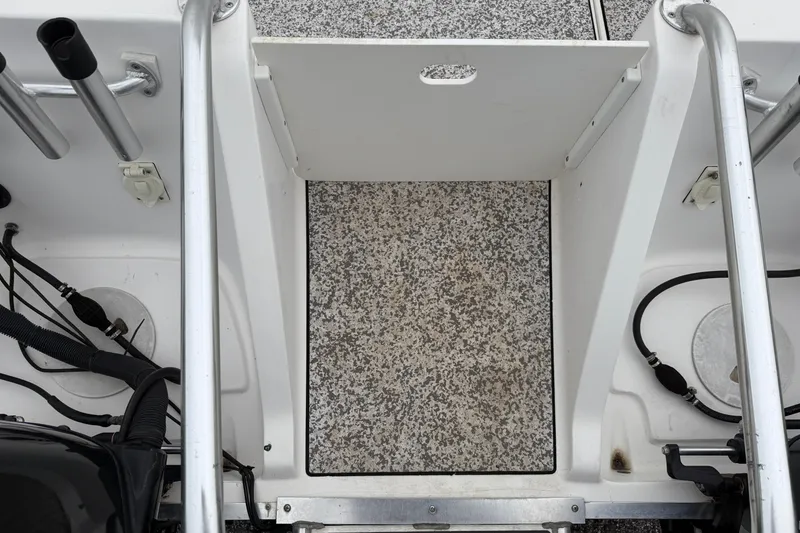 Slide: The Image of 2004 Pro Sports 2660 WA ProKat boat deck with rod holders and textured flooring. - 8