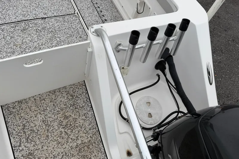 Slide: The Image of 2004 Pro Sports 2660 WA ProKat boat deck with rod holders and motor. - 9
