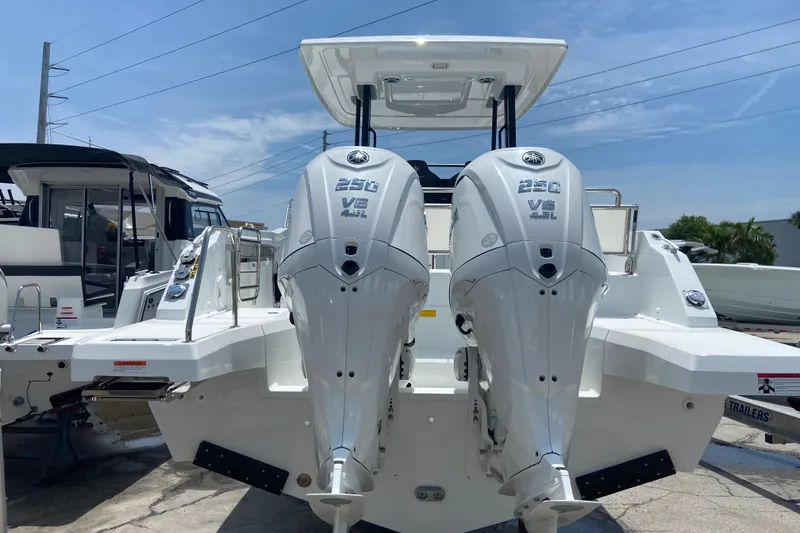 Slide: The Image of 2026 Jeanneau Leader 9.0 WA Series 2 with dual 250 V8 engines, docked outdoors. - 2