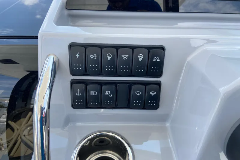 Slide: The Image of Control panel of 2026 Jeanneau Leader 9.0 WA Series 2 boat with various switches. - 20
