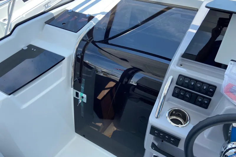 Slide: The Image of Cockpit view of 2026 Jeanneau Leader 9.0 WA Series 2 boat, featuring control panel and steering wheel. - 26