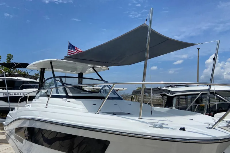 Slide: The Image of 2026 Jeanneau Leader 9.0 WA Series 2 boat with canopy and American flag. - 3