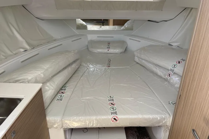 Slide: The Image of Interior cabin of 2026 Jeanneau Leader 9.0 WA Series 2, featuring cushioned seating. - 30