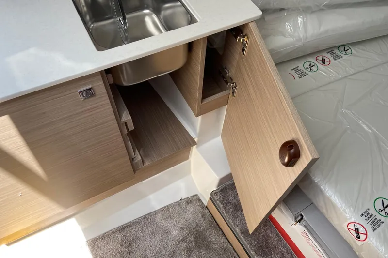 Slide: The Image of Interior view of 2026 Jeanneau Leader 9.0 WA Series 2, featuring a compact kitchenette. - 34