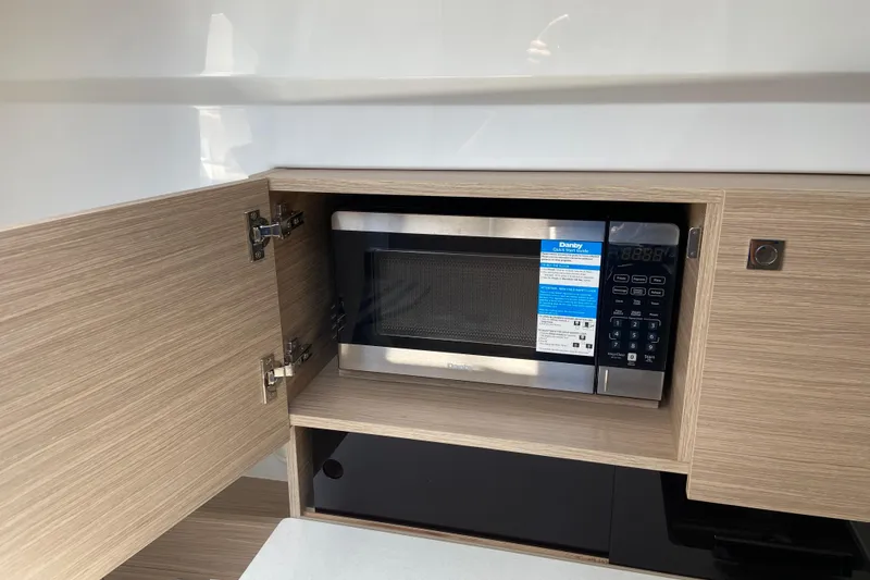 Slide: The Image of Microwave in Jeanneau Leader 9.0 WA Series 2 boat, 2026 model, wooden cabinet. - 36