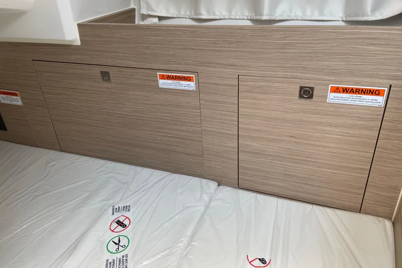 Slide: The Image of 2026 Jeanneau Leader 9.0 WA Series 2 cabin interior with warning labels and storage panels. - 38