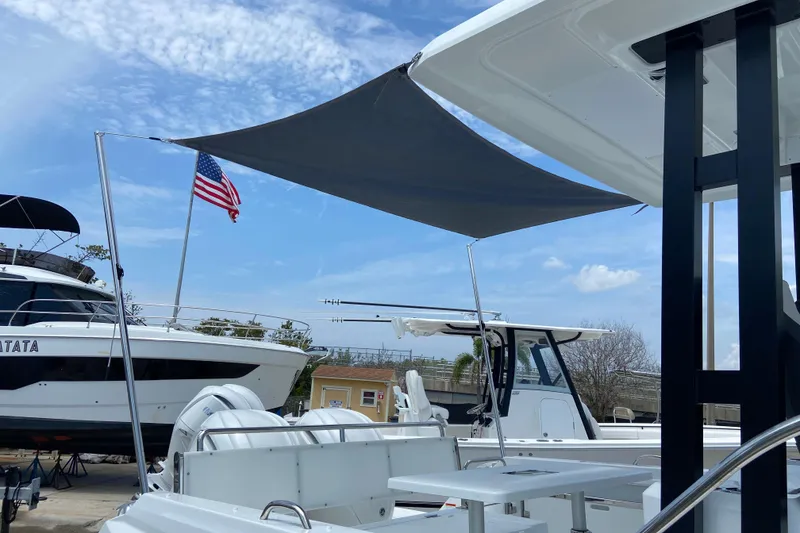 Slide: The Image of 2026 Jeanneau Leader 9.0 WA Series 2 boat with sunshade and American flag. - 4