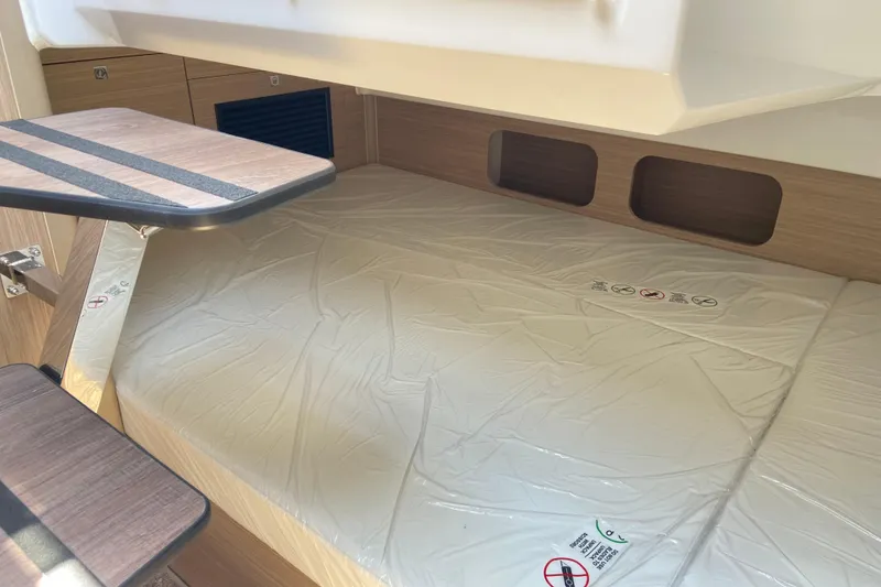 Slide: The Image of Interior cabin of 2026 Jeanneau Leader 9.0 WA Series 2, featuring a cozy sleeping area. - 41