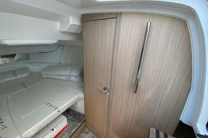 Slide: The Image of Interior cabin of 2026 Jeanneau Leader 9.0 WA Series 2 with wood finish and bedding. - 42