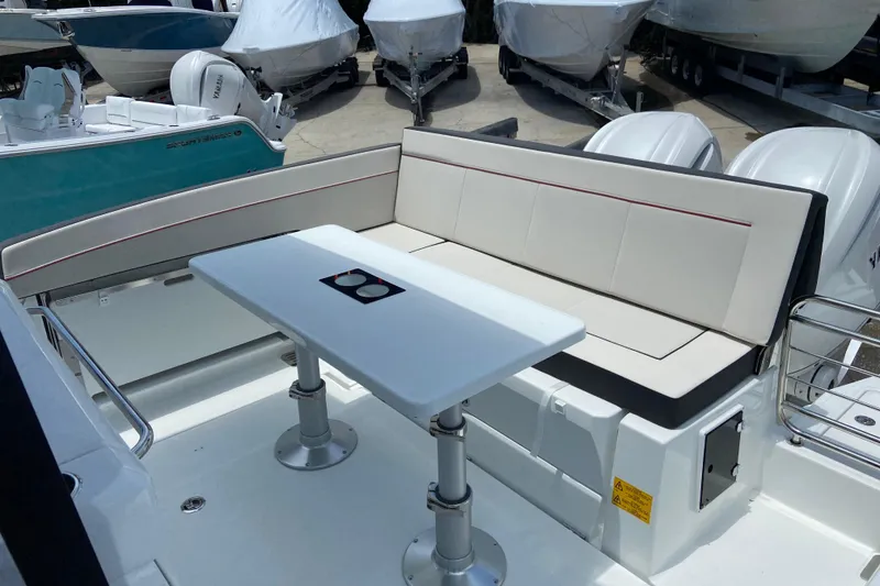 Slide: The Image of 2026 Jeanneau Leader 9.0 WA Series 2 boat interior with seating and table. - 7
