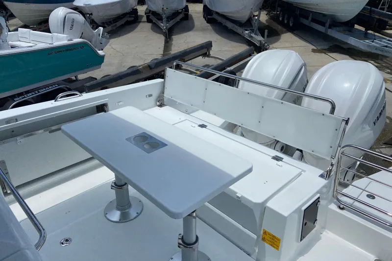 Slide: The Image of 2026 Jeanneau Leader 9.0 WA Series 2 boat deck with table and dual engines. - 8