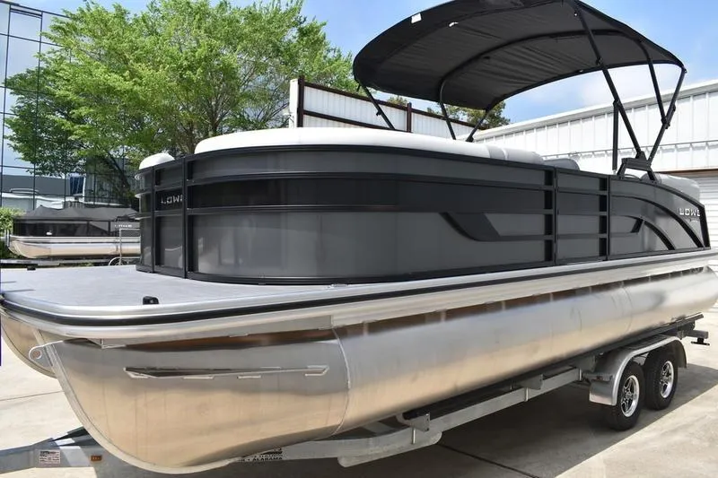 Slide: The Image of 2026 Lowe SS 230 WT Special pontoon boat on trailer, outdoor setting. - 10