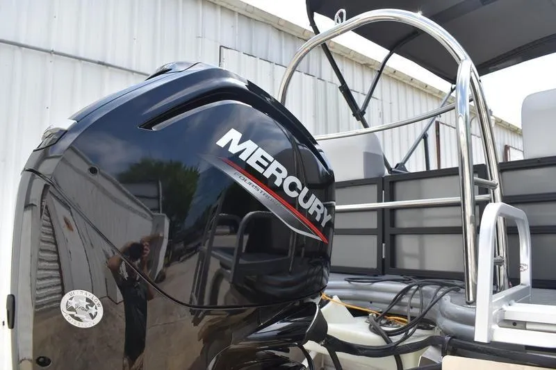 Slide: The Image of 2026 Lowe SS 230 WT Special boat with Mercury outboard motor, docked near a building. - 9