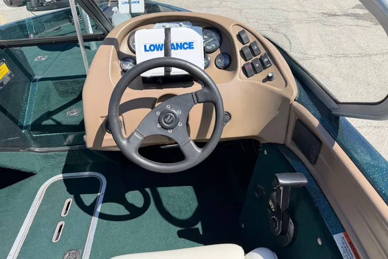 Slide: The Image of 1998 Ranger R97 boat dashboard with steering wheel and Lowrance navigation system. - 3