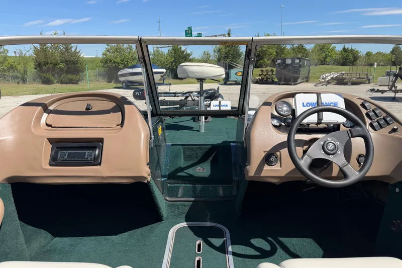 Slide: The Image of Interior view of a 1998 Ranger R97 boat with steering wheel and dashboard controls. - 4