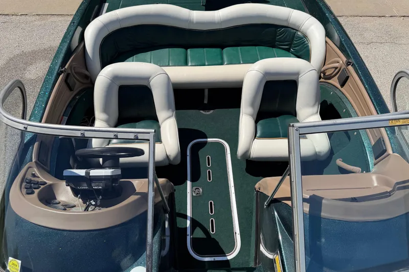 Slide: The Image of 1998 Ranger R97 boat interior with green and white seating, steering console, and windshield. - 5