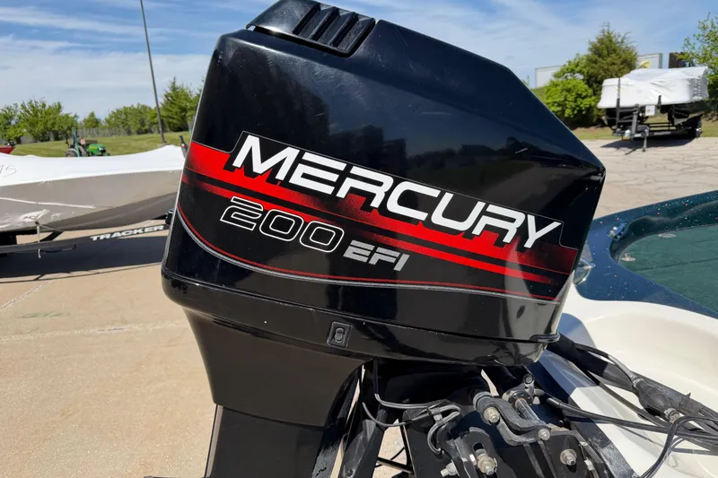 Slide: The Image of Mercury 200 EFI outboard motor on a 1998 Ranger R97 boat, parked outdoors. - 7