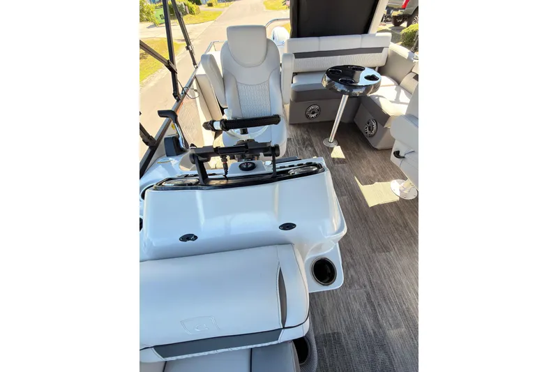 Slide: The Image of Interior of a 2021 Godfrey 2286 boat with seating and steering console. - 15