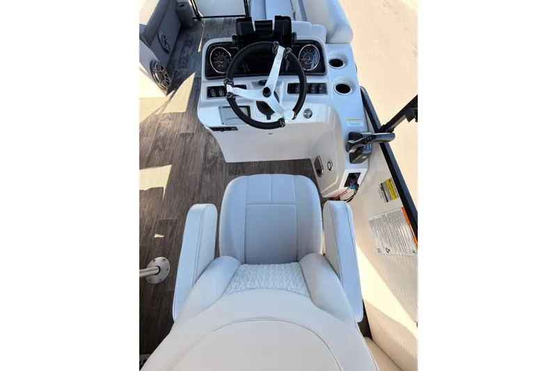 Slide: The Image of Interior view of a 2021 Godfrey 2286 boat cockpit with steering wheel and controls. - 18