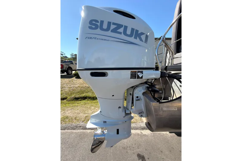 Slide: The Image of Suzuki outboard motor on a 2021 Godfrey 2286 boat, parked outdoors. - 19