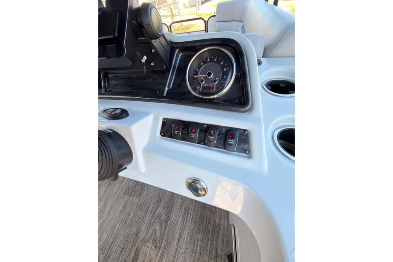 Slide: The Image of Dashboard of 2021 Godfrey 2286 boat with gauges and control switches. - 21