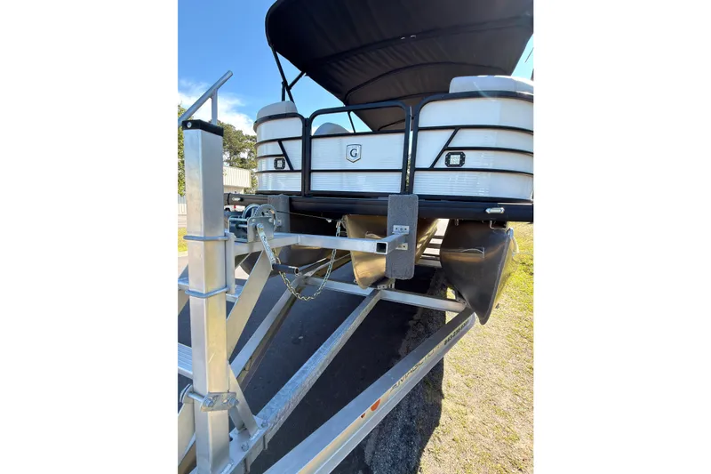 Slide: The Image of 2021 Godfrey 2286 pontoon boat on trailer, rear view with canopy and metal frame. - 5